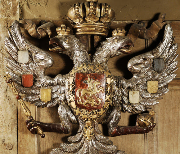 Carved wooden Russian imperial coat of arms on the wall of Dragon at Snowshill Manor, Gloucestershire